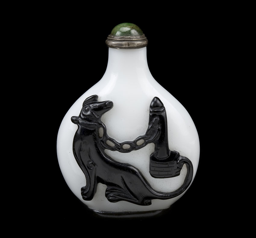 Overlay glass snuff bottle with black dog on one side and an eagle on the reverse
