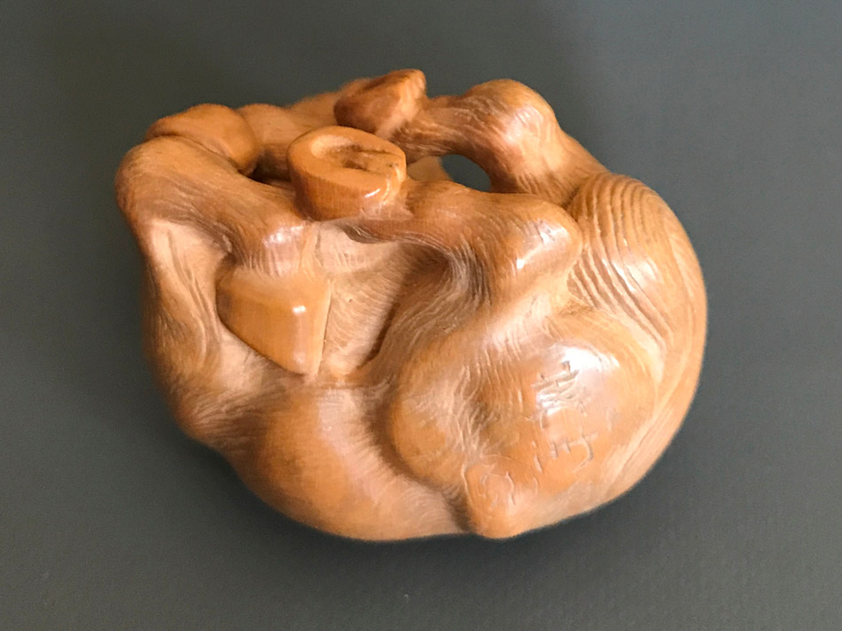 Boxwood netsuke of a rolling horse
