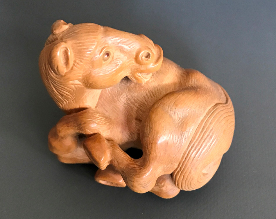 Boxwood netsuke of a rolling horse