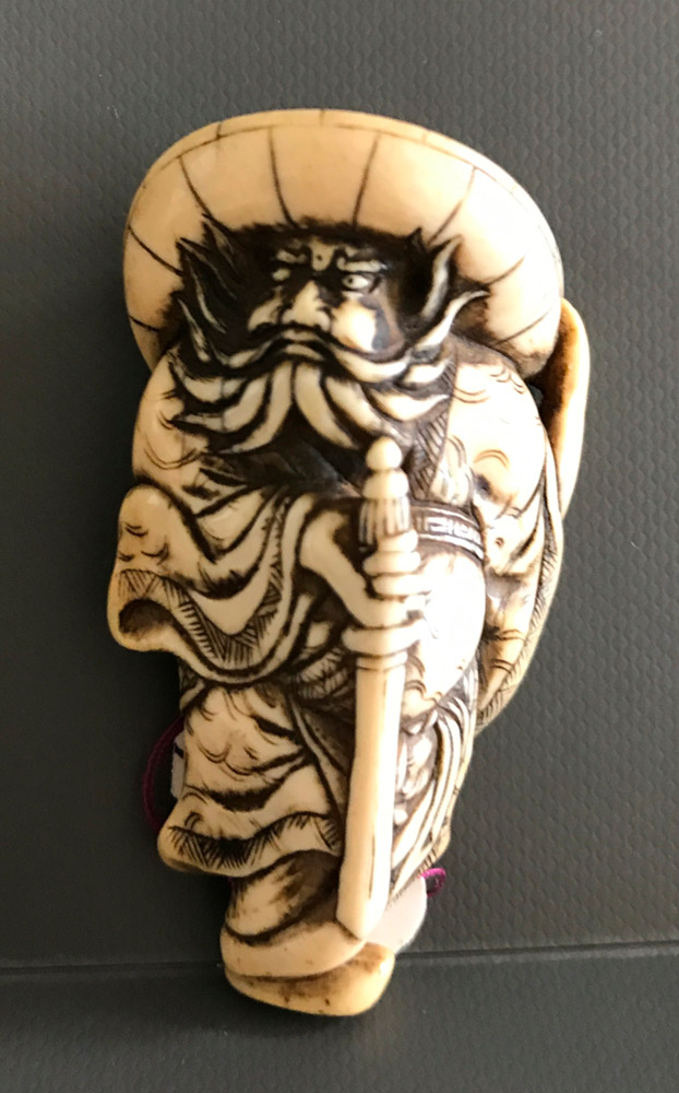 Ivory netsuke of Shoki holding his sword