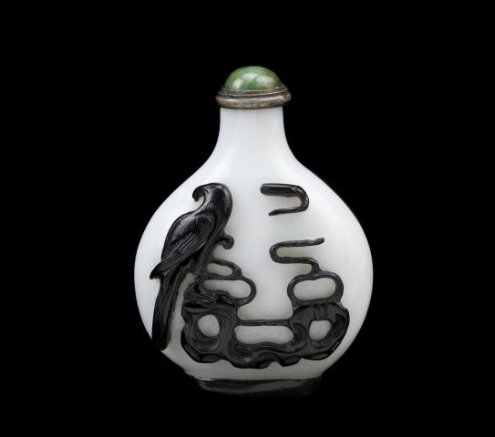 Overlay glass snuff bottle with black dog on one side and an eagle on the reverse